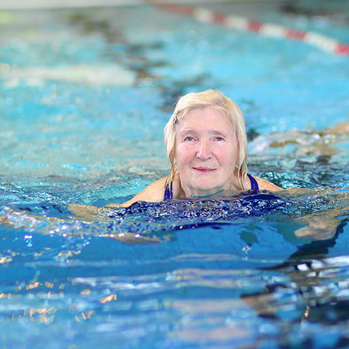 Healthy senior woman in swimming pool